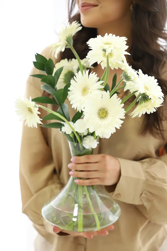 Mulher segurando um buquê de flores brancas